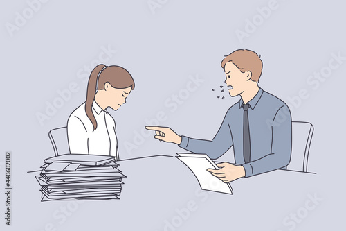 Conflict at work and angry boss concept. Furious director businessman sitting and swearing at sad unhappy worker girl with heap of documents on table in office 