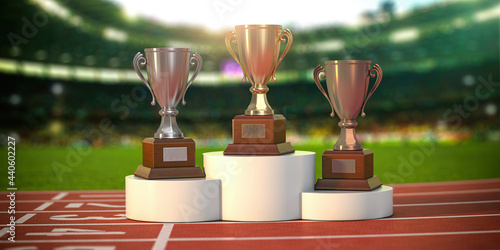 Fotografie Sport trophy cups on pedestal at the stadium