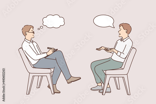 Business interview and head hunting concept. Young man job seeker sitting answering questions of recruiter looking at him and making notes in notepad vector illustration 