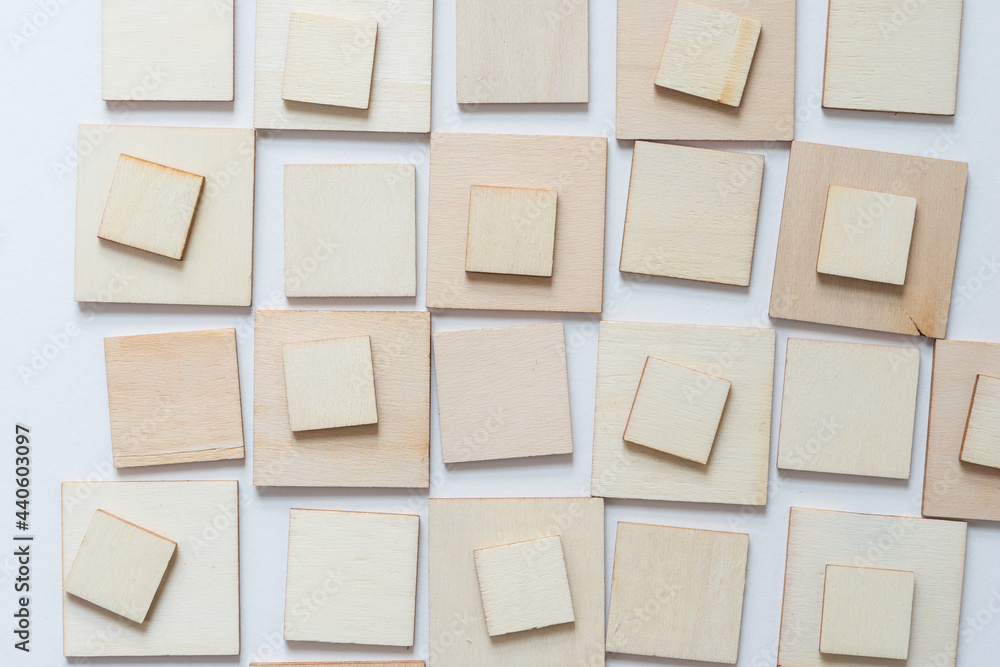 laser cut untreated or natural square wooden shapes arranged on a light background - photographed from above in a flat lay style with ambient light laser cut untreated or natural square wooden shapes arranged on a light background - photographed from above in a flat lay style with ambient light