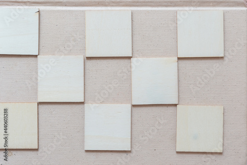 laser cut untreated or natural square wooden shapes arranged on a light background - photographed from above in a flat lay style with ambient light photo