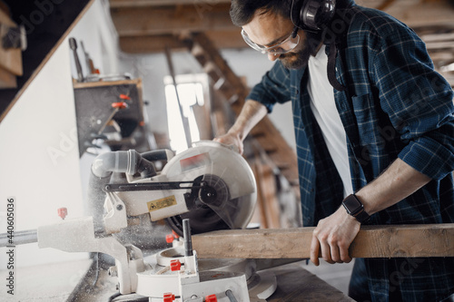 Carpenter working with circular saw