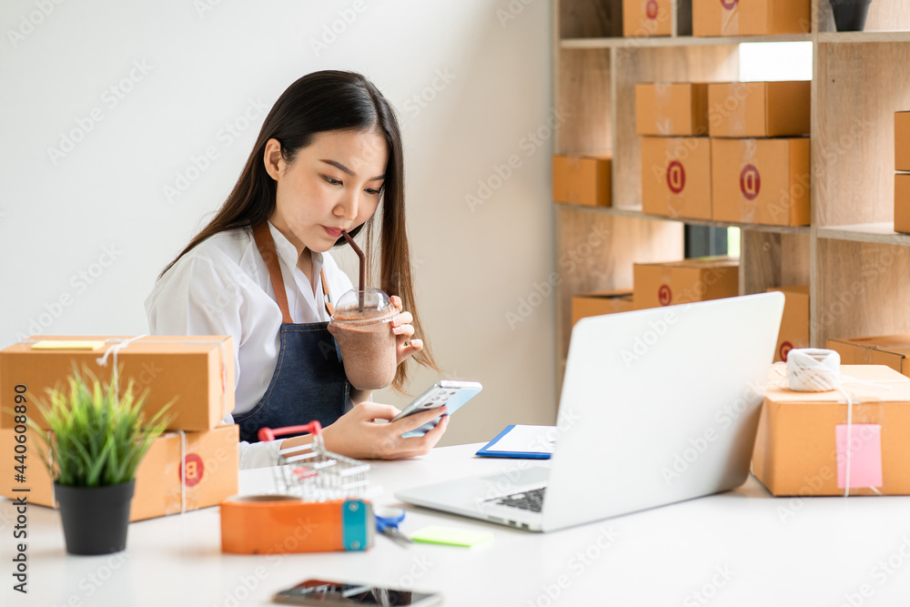 Portrait of Starting small businesses SME owners female entrepreneurs working on receipt box and check online orders to prepare to pack the boxes, sell to customers, sme business ideas online. Portrait of Starting small businesses SME owners female entrepreneurs working on receipt box and check online orders to prepare to pack the boxes, sell to customers, sme business ideas online.