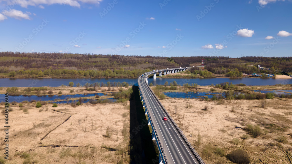 Long and high bridge over a large river. Beautiful nature. Sunny day. Beautiful architecture. Colorful photo. Long and high bridge over a large river. Beautiful nature. Sunny day. Beautiful architecture. Colorful photo.