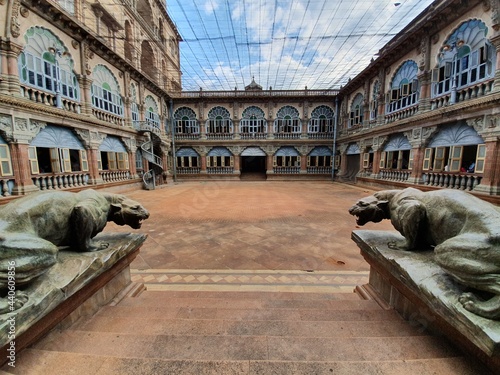 The courtyard inside the mysore palace, with two iconic sculptures of a tiger like animal. photo