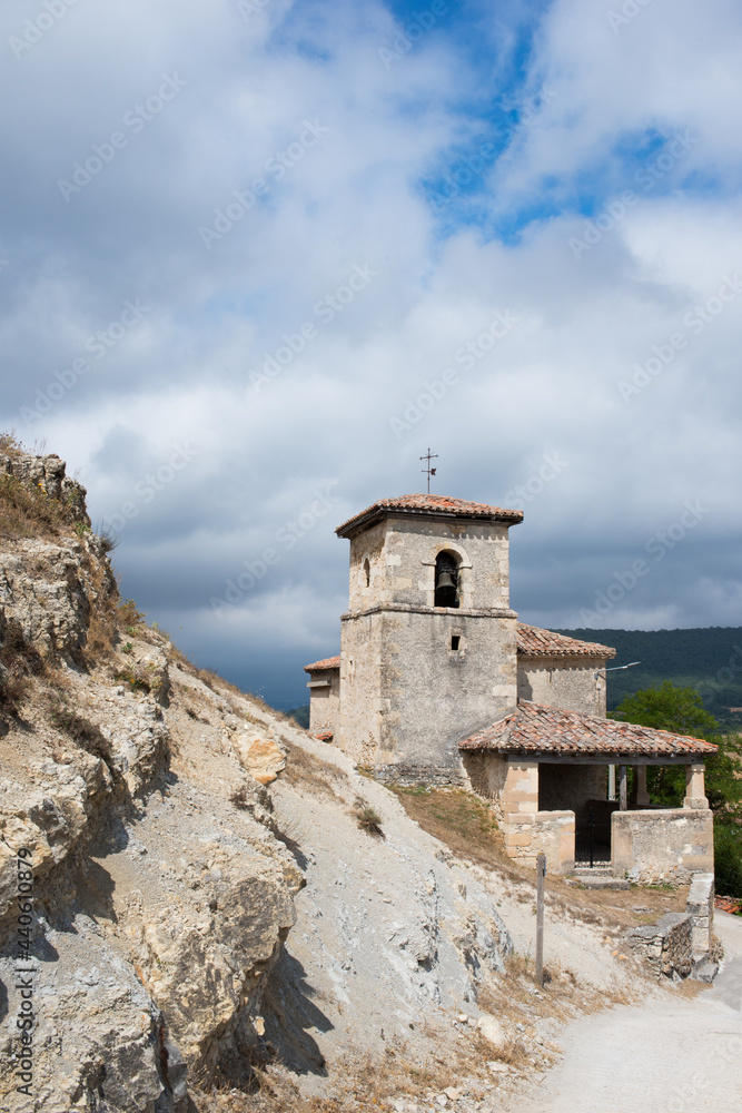 Beautiful old church of stone in Merindades. Blue sky with clouds, Burgos, Spain, Europe.