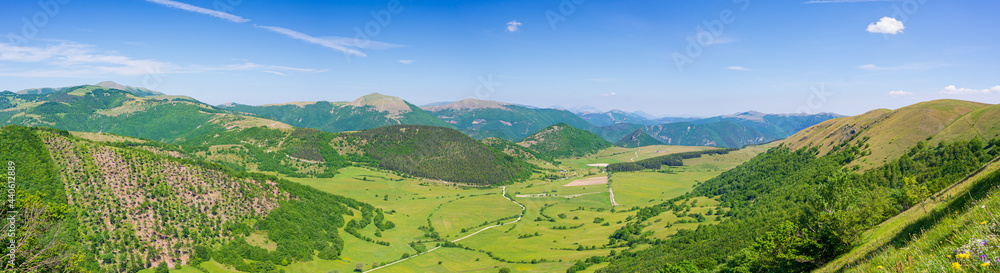Fototapeta premium Clear blue sky over Montelago highlands, Marche, Italy. Summer green landscape unique hills and mountains landscape, view from above.
