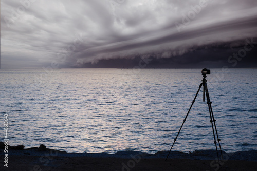 DSLR digital professional camera stand on tripod photographing Cloudy storm in the sea before the rain. tornado storms cloud above the sea. Monsoon season. Hurricane Florence. Hurricane Katrina.