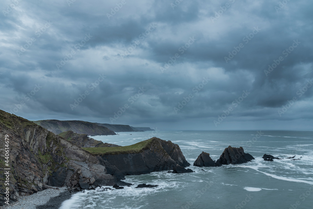 Stunning fine art landscape image of view from Hartland Quay in Devon England durinbg moody Spring sunset Stunning fine art landscape image of view from Hartland Quay in Devon England durinbg moody Spring sunset