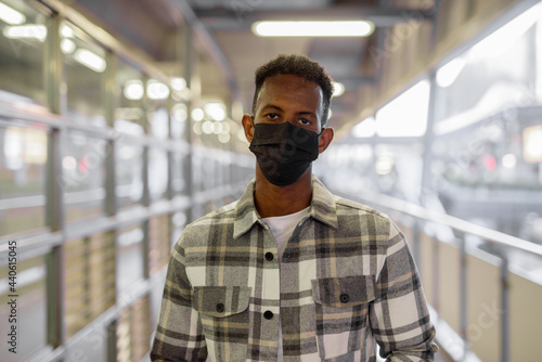 Portrait of African black man outdoors in city during summer wearing face mask © Ranta Images