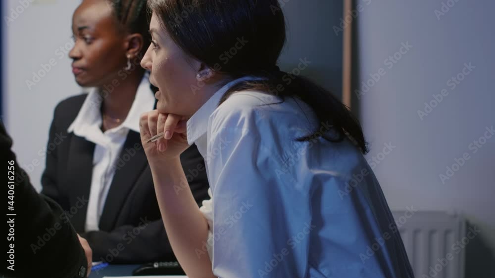 Entrepreneur woman discussing financial graphs using presentation monitor working in office meeting room late at night. Diverse multi ethnic businesspeople brainstorming company ideas Entrepreneur woman discussing financial graphs using presentation monitor working in office meeting room late at night. Diverse multi ethnic businesspeople brainstorming company ideas