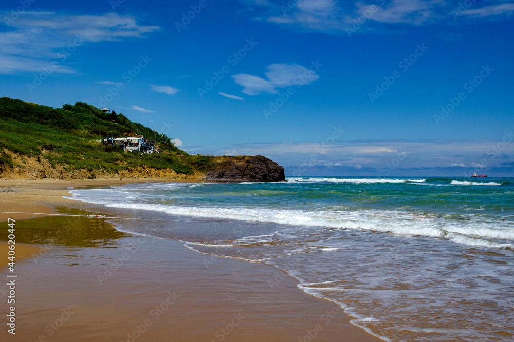 Beautiful sunny sand beach with waves