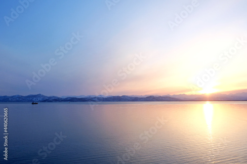 Sunset view of the Avacha Bay. Ships standing in the roadstead, mountains in the background. Petropavlovsk-Kamchatsky, Kamchatka Peninsula, Russia. photo