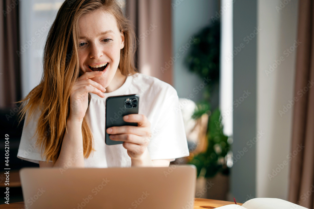 A young woman of European appearance in an apartment is playing with a gadget. Uses a mobile phone in his hands. Makes an online order with a credit card in an online store. A young woman of European appearance in an apartment is playing with a gadget. Uses a mobile phone in his hands. Makes an online order with a credit card in an online store.