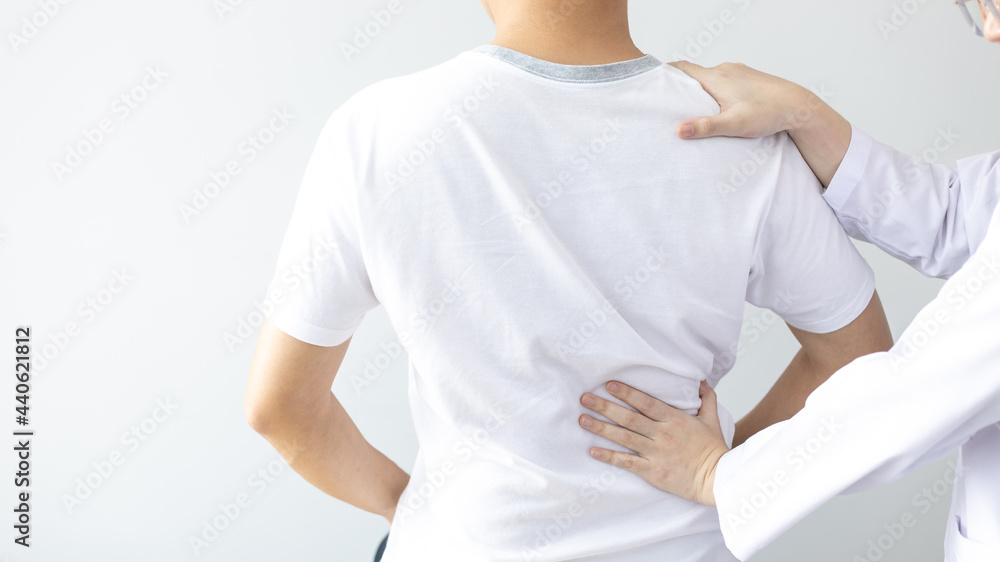 Physical therapy, Female physiotherapist treats back pain for a male patient attending a rehabilitation center, Bone arrangement, Non-surgical medical treatment, Modern medical techniques. Physical therapy, Female physiotherapist treats back pain for a male patient attending a rehabilitation center, Bone arrangement, Non-surgical medical treatment, Modern medical techniques.