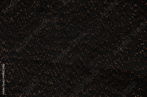 black fabric with shiny splashes in blurred focus, macro photo photo