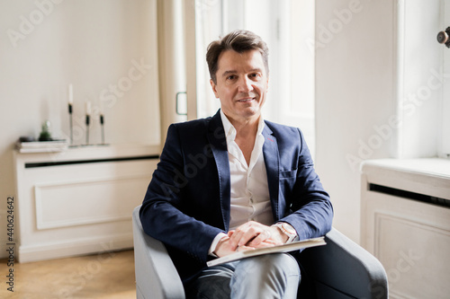 Tableau sur toile Lawyer teacher works at home reading a history book near the window