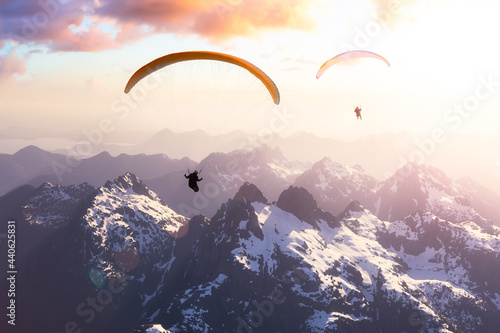 Adventure Composite Image of Paraglider Flying up high in the Rocky Mountains. Sunny Sunset Sky. Aerial Background from Vancouver Island, British Columbia, Canada. Extreme Sport Concept