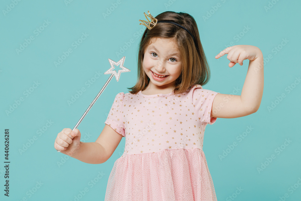 Little fun kid girl princess 5-6 years old wears pink dress crown diadem hold magic wand fairy stick isolated on pastel blue color background child studio. Mother's Day love family lifestyle concept. Little fun kid girl princess 5-6 years old wears pink dress crown diadem hold magic wand fairy stick isolated on pastel blue color background child studio. Mother's Day love family lifestyle concept.