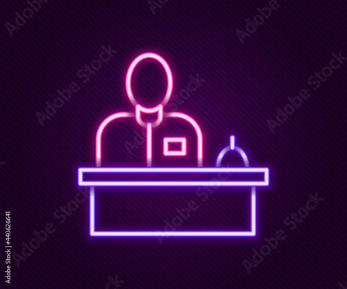 Glowing neon line Receptionist standing at hotel reception desk icon isolated on black background. Colorful outline concept. Vector