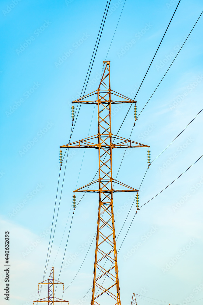 Production of fuel and electricity.Electrical networks with wires and transformers at sunset.Power transmission lines and from the power plant.Power lines with wires under voltage and electric current Production of fuel and electricity.Electrical networks with wires and transformers at sunset.Power transmission lines and from the power plant.Power lines with wires under voltage and electric current