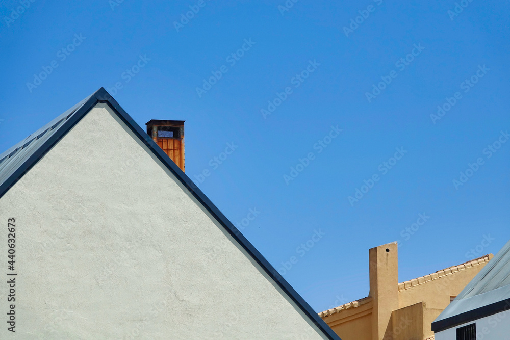 Slate roofs with chimneys on a sunny day