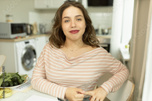 Cute woman sitting at kitchen