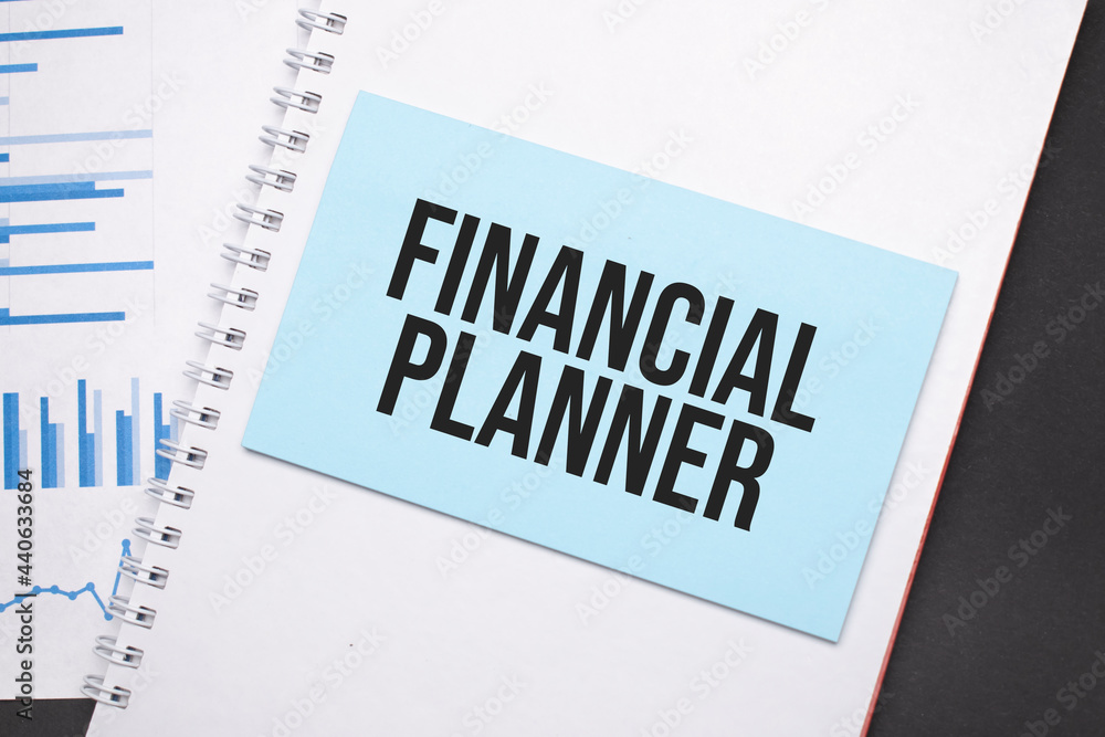 Paper plate with text FINANCIAL PLANNER. Diagram, notepad and blue ...