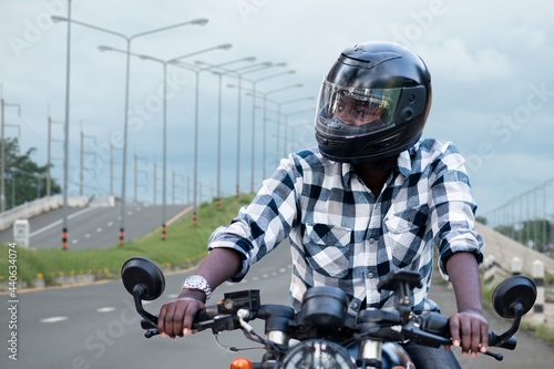African biker man in the helmet riding
