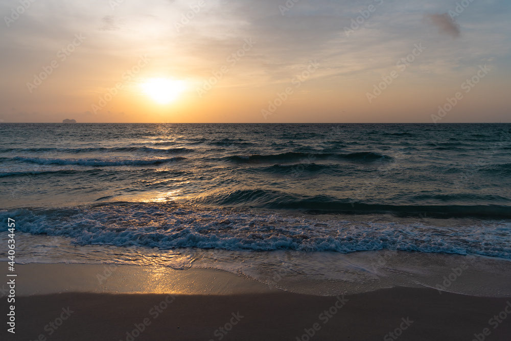 sunrise in ocean or sea at miami beach with silhouette of ship on sunset sky background, sunrise.