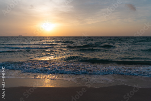 sunrise in ocean or sea at miami beach with silhouette of ship on sunset sky background, sunrise. © be free