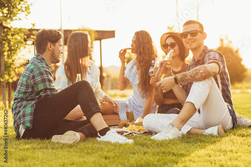 Photography group of young friends, handsome young women and men, students having fun at a p