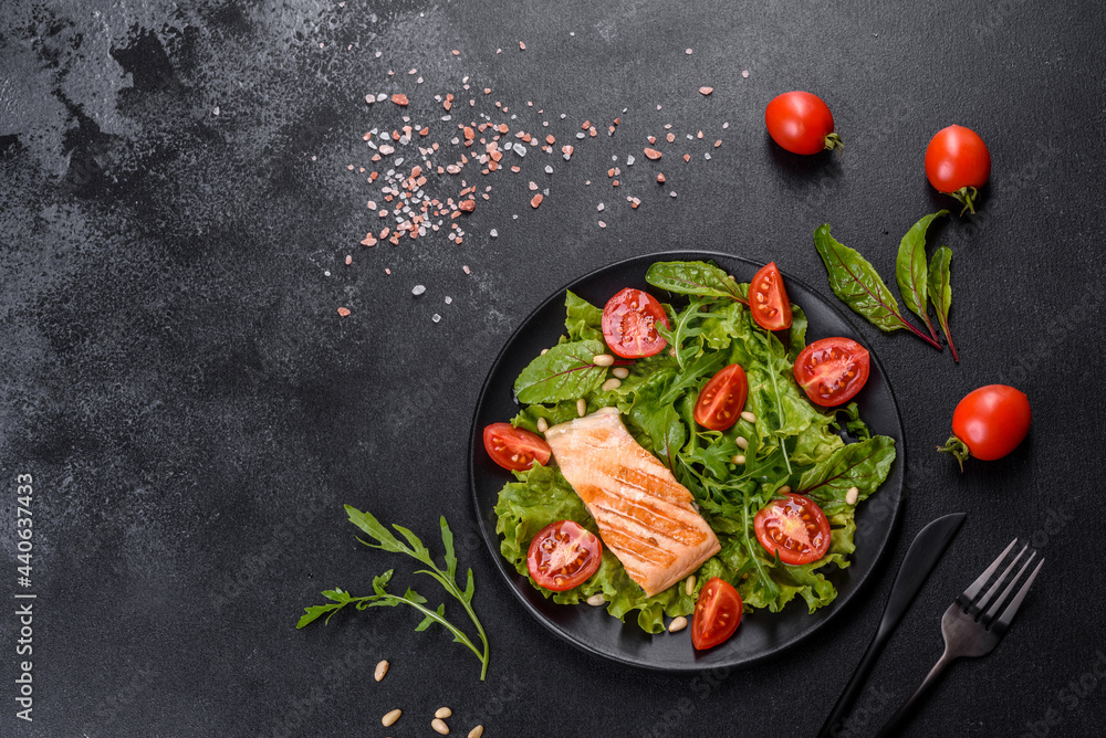 Delicious fresh salad with fish, tomatoes and lettuce leaves Delicious fresh salad with fish, tomatoes and lettuce leaves
