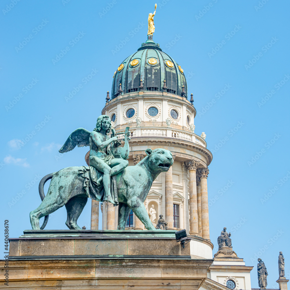 Statue of a panther with genius of music, an angel with wings and a harp, stringed musical instrument at Concert Hall (Konzerthaus), near French Church in Gendarmenmarkt in Berlin, Germany.