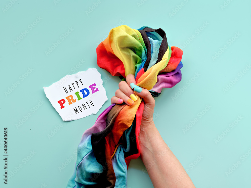 Happy Pride Month text on paper scrap. Hand with fake nails in colors ...