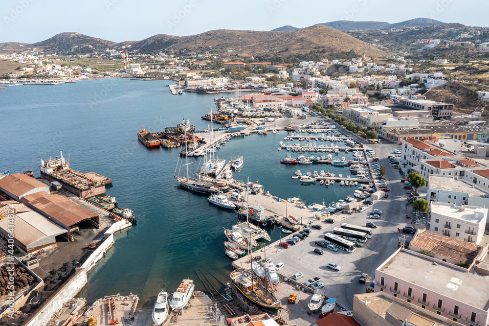 Syros island, Greece, aerial drone view. Saiboats moored at Ermoupolis port dock, yachts marina.