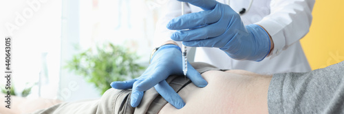Fotografie Nurse giving intramuscular injection of medicine into patients buttock