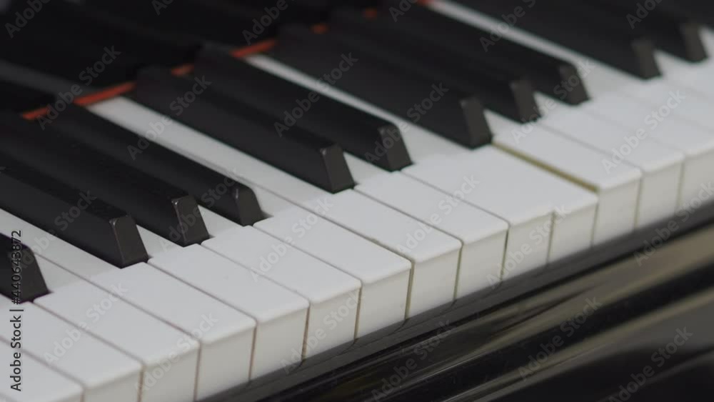 Grand piano. Professional piano keys self playing. close-up seamless loop. for classical musical music education. Black and white piano keys that play on their own. AI Self Playing Without Pianist. Grand piano. Professional piano keys self playing. close-up seamless loop. for classical musical music education. Black and white piano keys that play on their own. AI Self Playing Without Pianist.