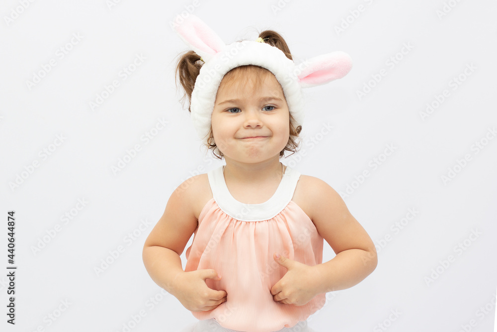 Adorable little girl wearing bunny ears on white background Adorable little girl wearing bunny ears on white background
