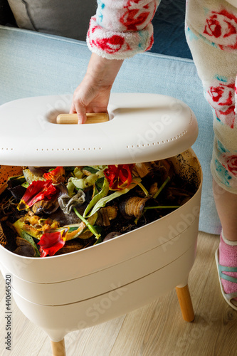 A woman opens a home composter, The zero waste concept,