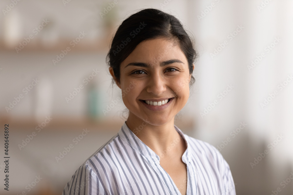 Headshot close up portrait of smiling young Indian woman look at camera feel positive optimistic. Profile picture of happy millennial mixed race female renter or tenant. Diversity concept. Headshot close up portrait of smiling young Indian woman look at camera feel positive optimistic. Profile picture of happy millennial mixed race female renter or tenant. Diversity concept.