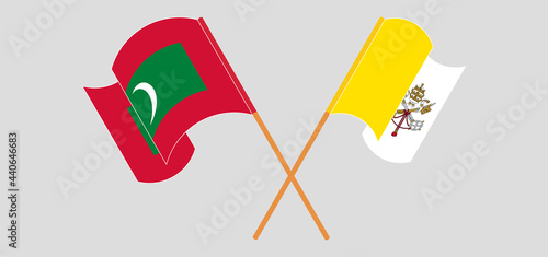 Crossed and waving flags of Maldives and Vatican