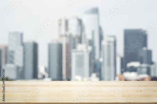 Empty table top made of wooden dies with blurry city view at daytime on background  template
