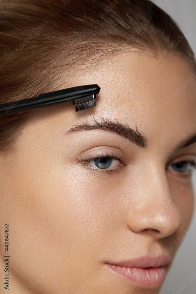 Eyebrows Care. Young Female Model Shaping Brown Eyebrows.