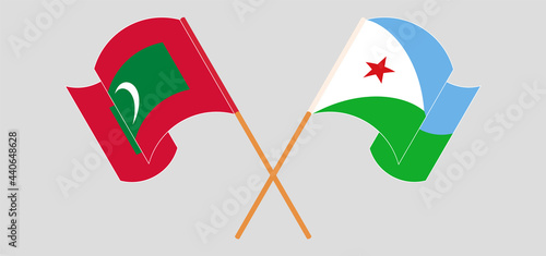 Crossed and waving flags of Maldives and Djibouti