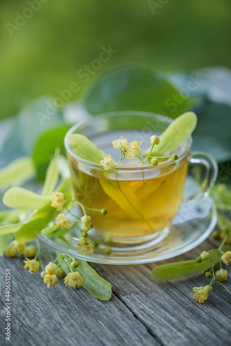A cup of fresh green tea with linden flowers, hot drink, herbal medicine