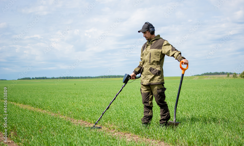 Metal search. Man with electronic metal detector device in his hand. Search for antique coins. Metal search. Man with electronic metal detector device in his hand. Search for antique coins.