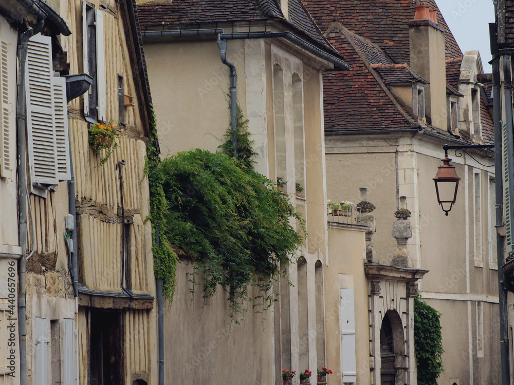 Street view of medieval French city of Auxerre in Yonne, Burgundy. Romantic atmosphere of historic France urban heart while France opens its borders for tourists after Covid 19 coronavirus pandemic.