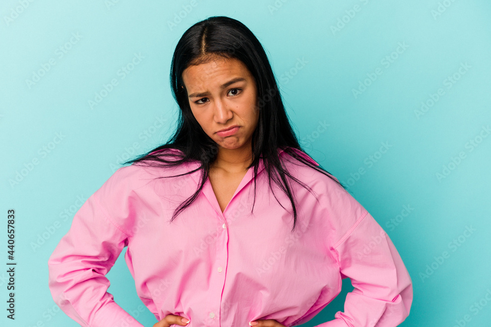 Fototapeta premium Young Venezuelan woman isolated on blue background sad, serious face, feeling miserable and displeased.