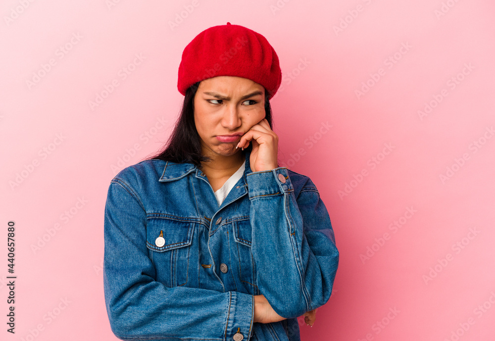 Young Venezuelan woman isolated on pink background who feels sad and pensive, looking at copy space. Young Venezuelan woman isolated on pink background who feels sad and pensive, looking at copy space.